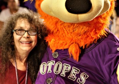 woman with Isotopes mascot