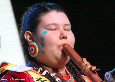 Miss Indian World contestant playing flute