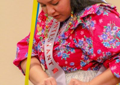 woman fixing her contestant pin