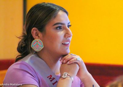 woman listening to Miss Indian World speak