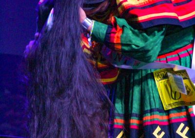 Miss Indian World contestant tying her hair