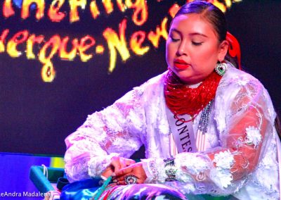 Miss Indian World contestant swaddling a baby