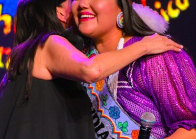 Miss Indian World hugging presenter