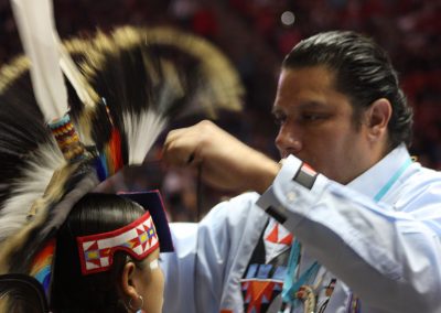 man putting headpiece on child