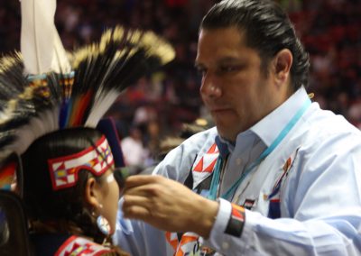 man putting headpiece on child