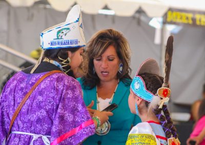 woman talking with two girls from Gathering of Nations