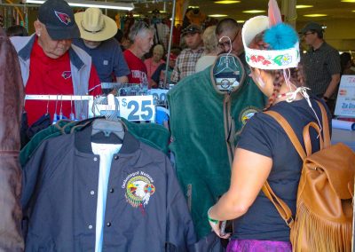 woman shopping for Gathering of Nations jacket