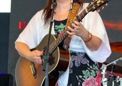 Woman playing guitar and singing