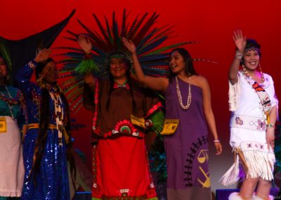 women on stage waving